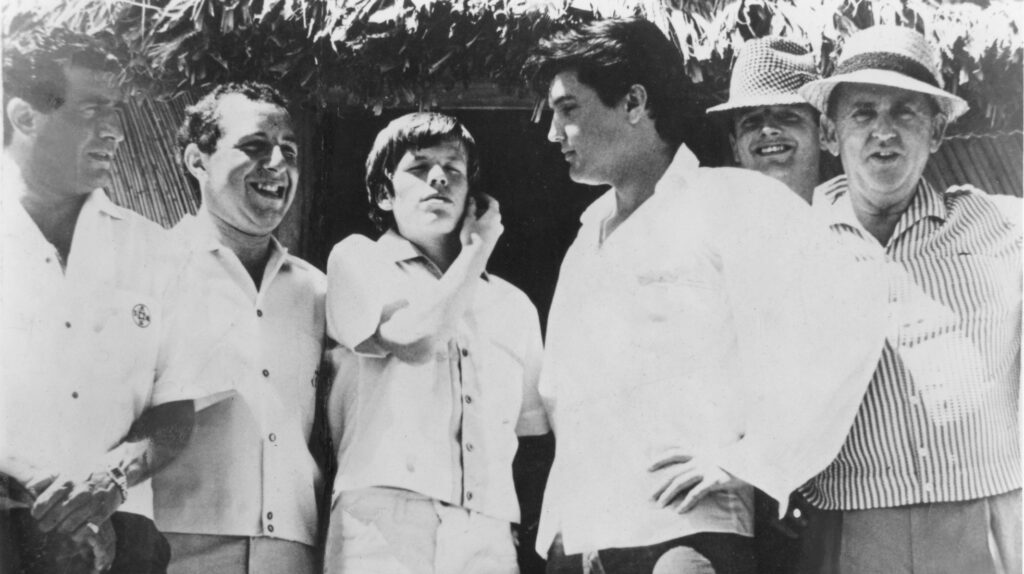 Paul R. Catalana, Herman's road manager, Peter Noone, Elvis, DJ Tom Moffatt & Colonel Parker in Hawaii 1965. Photograph courtesy of Lynn Catalana.