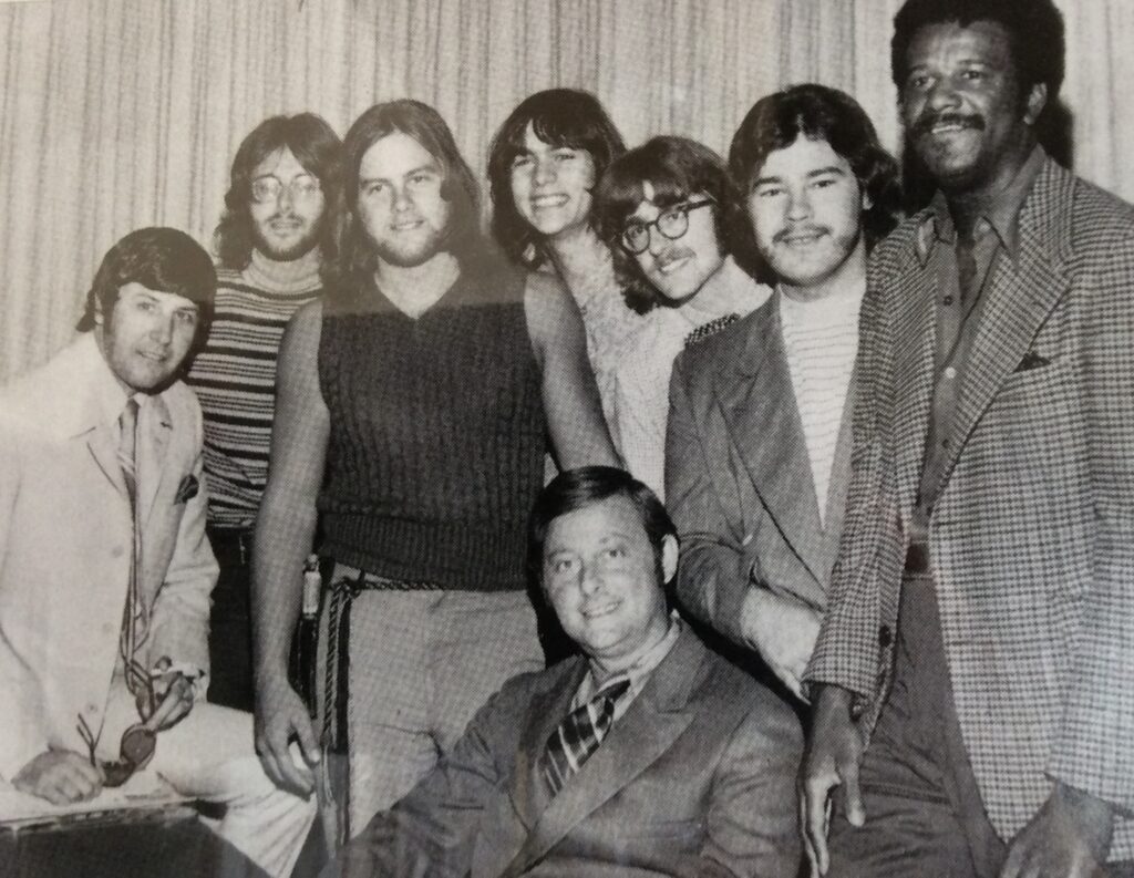 People! with band manager and Wally Amos (right), founder of Famous Amos chocolate chip cookies.